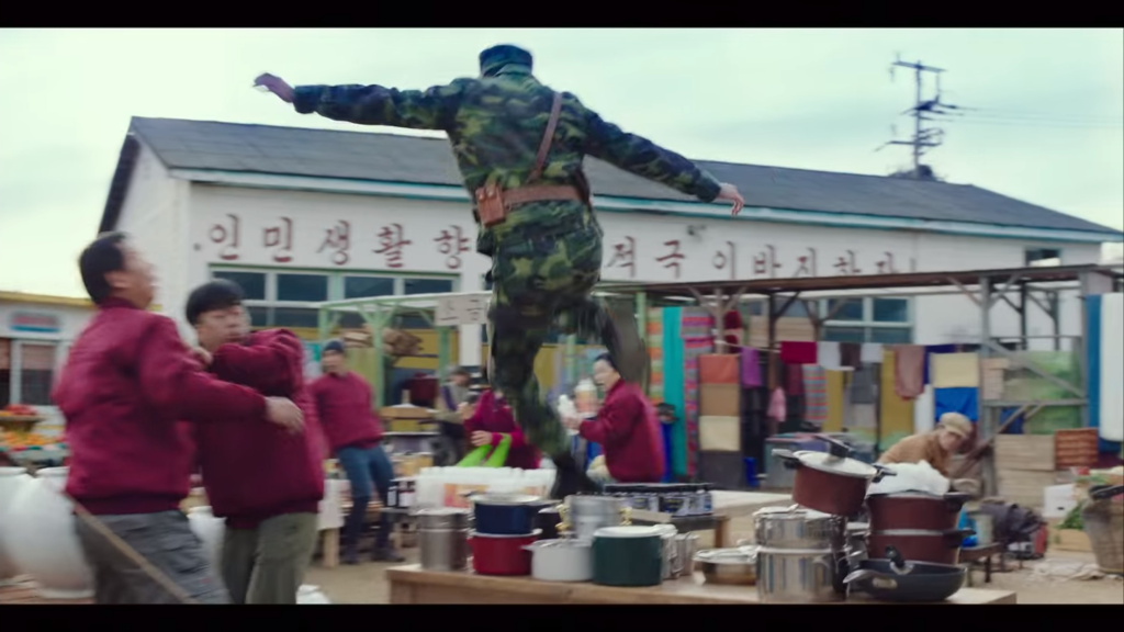 Captain Ri jumps over a table in pursuit of a shoplifter