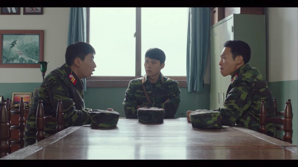 Captain Ri discussing Se-ri's behavior with some of his men
